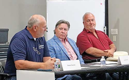 Logger Dennis Shenick (left) recounts the many times he has seen wolves between his logging equipment and his concerns for his safety and that of his employees. Looking on are Hunter Nation founder and CEO Keith Mark and State Sen. Cory Tomczyk (R-Mosinee) (right). (Photo by Beckie Gaskill/Lakeland Times)