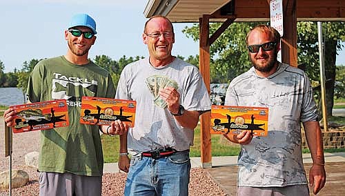 Adam Kolbeck (left) and Alex Wollack t(right), pictured with tournament emcee Phil Skoug, took first place at the Up/Down tournament, run by the Wisconsin Bass Team Trail, with a two-day combined weight of 26.78 pounds. (Photo by Beckie Gaskill/Lakeland Times)