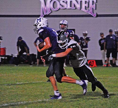 Brooks Lenz tackles Mosinee’s Treve Stoffel during the third quarter Friday, Sept. 13 at Veterans Park in Mosinee. (Photo by Brett LaBore/Lakeland Times)