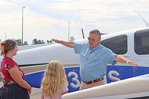 Pilot Bill Stengl, standing next to his Beechcraft Debonair, explains flight dynamics before one of four flights he made during Young Eagles Day at Lakeland Airport on Saturday, Sept. 14. (Photo by Kate Reichl/Lakeland Times)