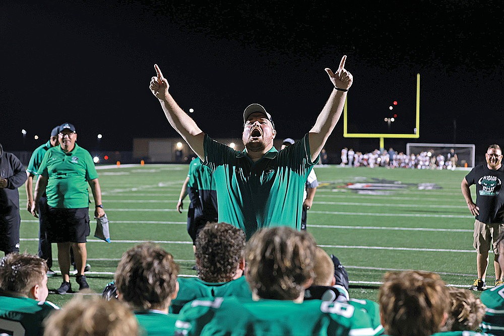 Rhinelander High School football coach Aaron Kraemer celebrates in the postgame huddle after the Hodags defeated the Wausau East Lumberjacks 28-7 in a GNC football game at Mike Webster Stadium Friday, Sept. 13. The 3-1 Hodags will look to keep rolling tonight as they travel to 1-3 Tomahawk. (Bob Mainhardt for the River News)