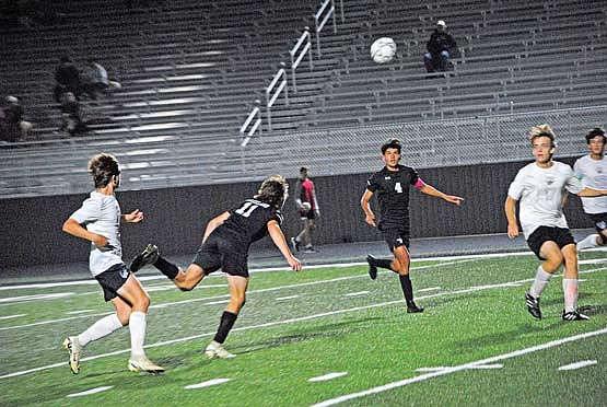 Marshall Holmquist (11) uses a header to pass the ball to Dominic Gironella (4) in the second half against Antigo Thursday, Sept. 19 at IncredibleBank Field in Minocqua. Gironella would go on to score the fourth goal of the game. (Photo by Brett LaBore/Lakeland Times)