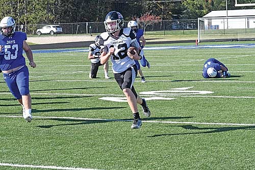 Gabe Karch runs for 13 yards in the fourth quarter against Merrill Saturday, Sept. 28 at Jay Stadium in Merrill. Karch got his first varsity playing time when he took over for an injured Brooks Lenz at quarterback. (Photo by Brett LaBore/Lakeland Times)