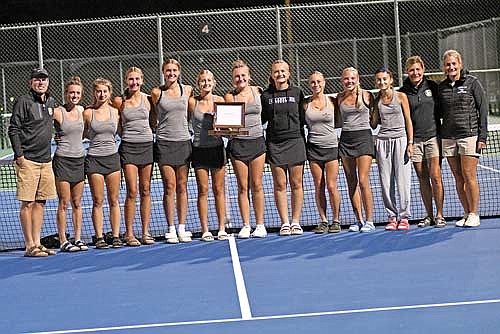 Team pictured, from left, coach Tom Oestreich, Elise Lamers, Chance Jacobs, Alyssa Erickson, Kristina Ouimette, Lila Biller, Sarah Barton, Ellie Baker, Norah Strasburg, Ali Timmerman, Sierra Wallace, assistant coach Judy Jurries and assistant coach Kim Olson celebrate their conference championship following the Great Northern Conference Tournament Thursday, Sept. 26 at the Lakeland Union High School tennis courts in Minocqua. The Thunderbirds totaled 113 points in their second straight conference title. (Photo by Brett LaBore/Lakeland Times)