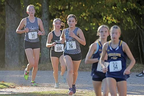 Ada Ernst runs in front of Rhinelander’s Brynn Teter and Sherri Handeland (77) during the Three Lakes Invite Thursday, Sept. 26 at Big Stone Golf Course in Three Lakes. Ernst had the fastest time for the Thunderbirds at 21:44.6, good for third place. (Photo by Jeremy Mayo/River News)