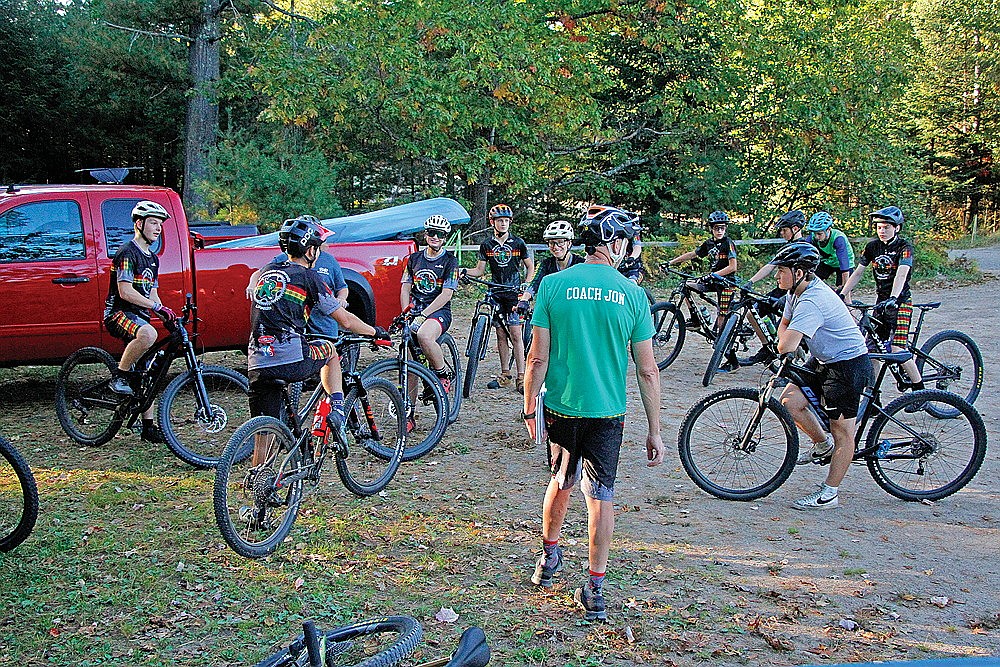 Members of the Rhinelander Northwoods Composite mountain bike team listen to head coach Jon Lester prior to practice at Tesomas Scout Camp in Pine Lake Monday, Sept. 30. The team will host the Hodag Hustle Mountain Bike Festival, a three-day weekend, that will culminate with Round 5 of the Wisconsin Interscholastic Cycling League season on Sunday, Oct. 6. (Jeremy Mayo/River News)