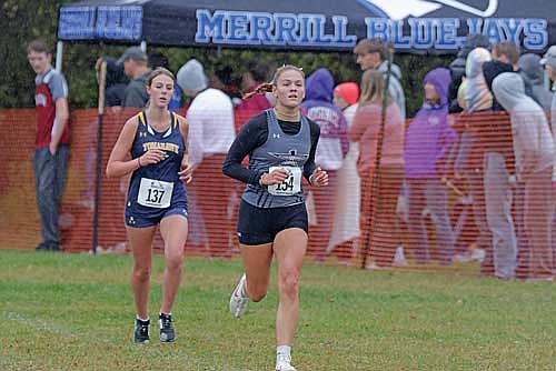 Stella Meza runs ahead of Tomahawk’s Lydia Shaney in the Tomahawk Invite Saturday, Oct. 12 at Tomahawk High School. Meza finished third at 20:53.9. (Photo by Jeremy Mayo/River News)