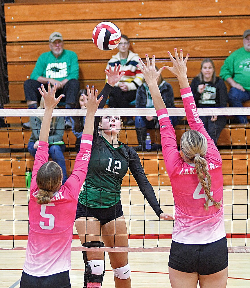 Rhinelander's Callie Hoerchler looks to hit between a double block by Lakeland's Sloane Timmerman (5) and Stina Peterson (4) during a GNC volleyball match in Medford Saturday, Oct. 12. (Brett LaBore/Lakeland Times)