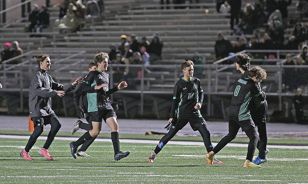 Members of the Rhinelander High School boys’ soccer team rush to congratulate Asher Rivord, far right, after Rivord scored a shootout-clinching penalty kick to give Rhinelander a 4-1 shootout win over Medford in a GNC match at Mike Webster Stadium Tuesday, Oct. 15. The teams played to a 1-1 tie in regulation. (Bob Mainhardt for the River News)