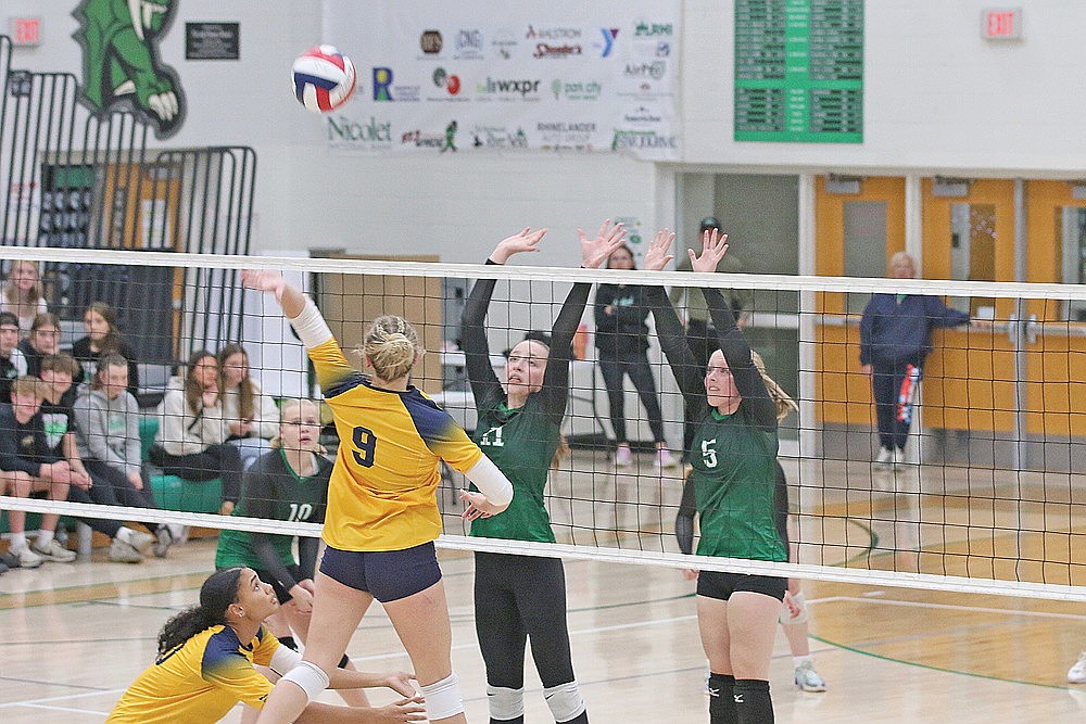 Rhinelander’s Kelsi Beran (11) and Cassidy Lindner (5) attempt to block Tomahawk’s Alicia Voermans during the first set of a GNC volleyball match at the Jim Miazga Community Gymnasium Tuesday, Oct. 15. (Bob Mainhardt for the River News)