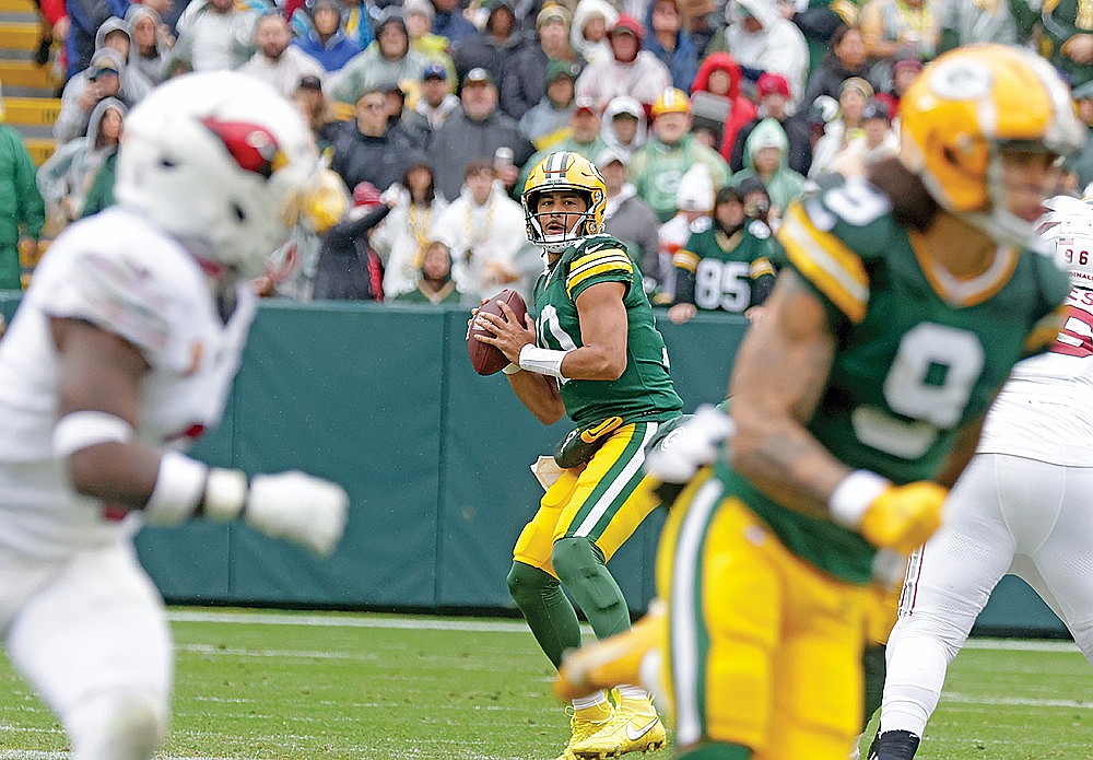 Green Bay Packers quarterback Jordan Love prepares to throw a deep pass to receiver Christian Watson for a touchdown during the second quarter of an NFL football game against the Arizona Cardinals at Lambeau Field Sunday, Oct. 13.