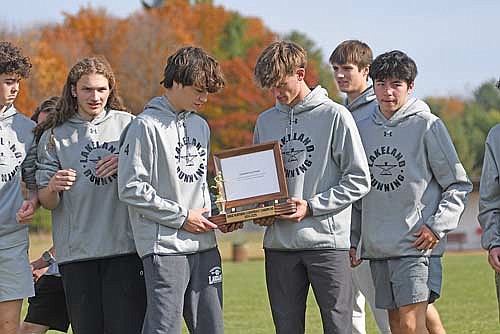 The Lakeland boys’ cross country team holds the trophy after winning the Great Northern Conference title for a third straight year Saturday, Oct. 19 at Northland Pines High School in Eagle River. Thunderbirds, pictured from left, Barrett Eggen, Braelen Hesch, Erik Anderson, Parker McKinney, Ashton Bremer, Ati Gyuro and Alton Jackson won with 36 points. (Photo by Brett LaBore/Lakeland Times)