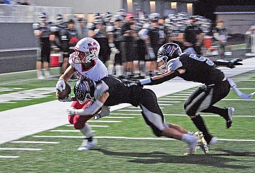 Tyson Redman (4) stops Medford’s Paxton Rothmeier from scoring a two-point conversion with Evan Zoch (5) in pursuit during the first quarter Friday, Sept. 20 at IncredibleBank Field in Minocqua. (Photo by Brett LaBore/Lakeland Times)