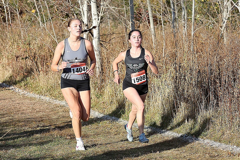 Rhinelander’s Brynn Teter (1508) races Lakeland’s Stella Meza (1404) during a WIAA Division 2 girls’ cross country sectional race in Colby Friday, Oct. 25. (Bob Mainhardt for the River News)