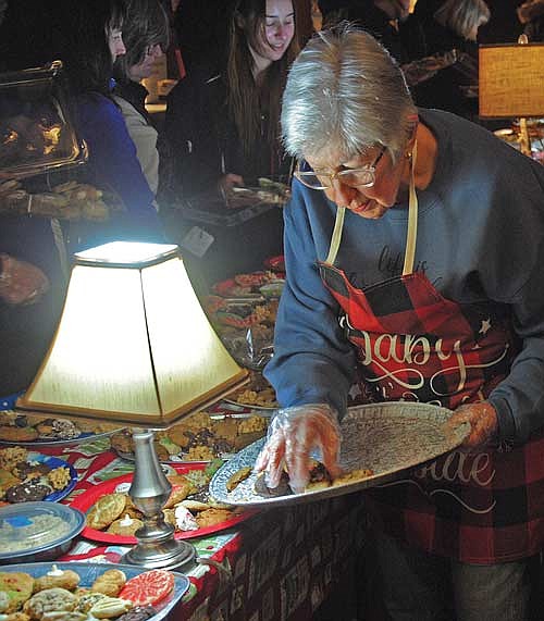 Fran Schroeder puts more homemade baked items out for sale during last year’s Friends of the Boulder Junction Public Library Annual Cookie Walk in Boulder Junction. (Photo by Brian Jopek/Lakeland Times)