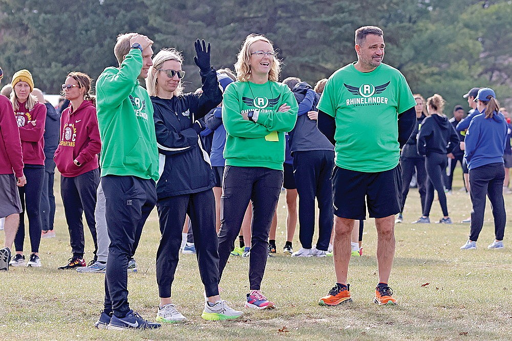 Rhinelander High School cross country coaches, from left to right, Bennett Rozek, Tara Gremban, Mellisa Krueger and M.J. Laggis watch their team warm up prior to the start of the WIAA Division 2 boys’ state cross country meet in Wisconsin Rapids Saturday, Nov. 2. (Jeremy Mayo/River News)