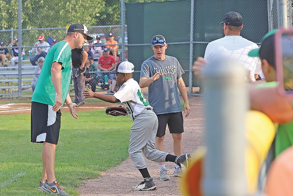 In this 2023 file photo, Dan Bauer, left, high-fives Jaxon Eades prior to a 10U Little League All-Star game in Wausau. Bauer led Hodag Little League teams to the Wisconsin state tournament in 2022 and 2023. (Bob Mainhardt for the River News)