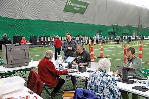 City Clerk Austyn Zarda, right, helps a voter Tuesday, Nov. 5, 2024 at the Hodag Dome in Rhinelander. (Photo by Bob Mainhardt for the River News)