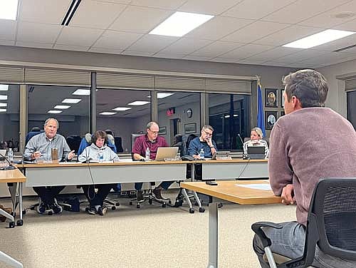 Minocqua town supervisor Billy Fried, left, speaks to Will Jeffery, who sought approval from the town board to hold two American Pond Hockey events in February using town facilties, while the other board members — Sue Heil, Mark Hartzheim, Brian Fricke and Erika Petersen — listen during a meeting on Wednesday, Nov. 6, in Minocqua. (Photo by Trevor Greene/Lakeland Times)