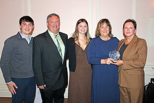 WNA executive director Beth Bennett, right, presents Roben Haggart with the Sunshine in Government Award. Next to Haggart, from left, are her son Matt, husband Rob and daughter Megan. (Contributed photograph)