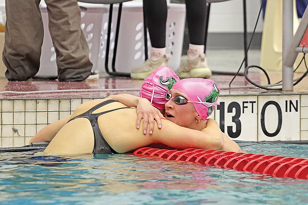 Rhinelander’s Vivian Lamers hugs teammate Ella Heck after the two finished first and second in the opening heat of the 50-yard freestyle during the WIAA Division 2 state girls’ swim meet in Waukesha Friday, Nov. 15. Though the Hodags finished a meet-best 28 points over their projected total, it was not enough to catch Whitefish Bay or Madison Edgewood for the top two positions overall at state. (Jeremy Mayo/River News)