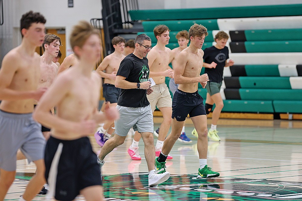 Rhinelander High School boys’ basketball coach Derek Lemmens jogs with his team during practice in the Jim Miazga Community Gymnasium Monday, Nov. 18. Monday marked the first-day of practice for high school boys’ basketball, boys’ swimming and wrestling teams in the state. (Bob Mainhardt for the River News)