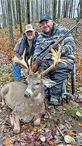 Mike Kramer and his son Jim Kramer pose for a photo with the buck Jim shot during a guided hunt a Forest of Antlers on Oct. 25 in Harshaw. (Contributed photograph)