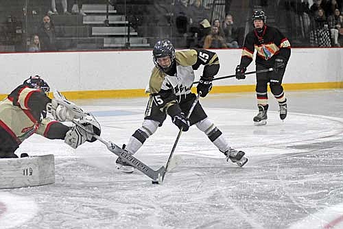 Sylvester Allen gets by Pacelli goalie Isaac Andrich for his first goal during the third period Tuesday, Nov. 26 at Lakeland Hawks Ice Arena in Minocqua. Allen scored his first-ever varsity goals in the opener. (Photo by Brett LaBore/Lakeland Times)