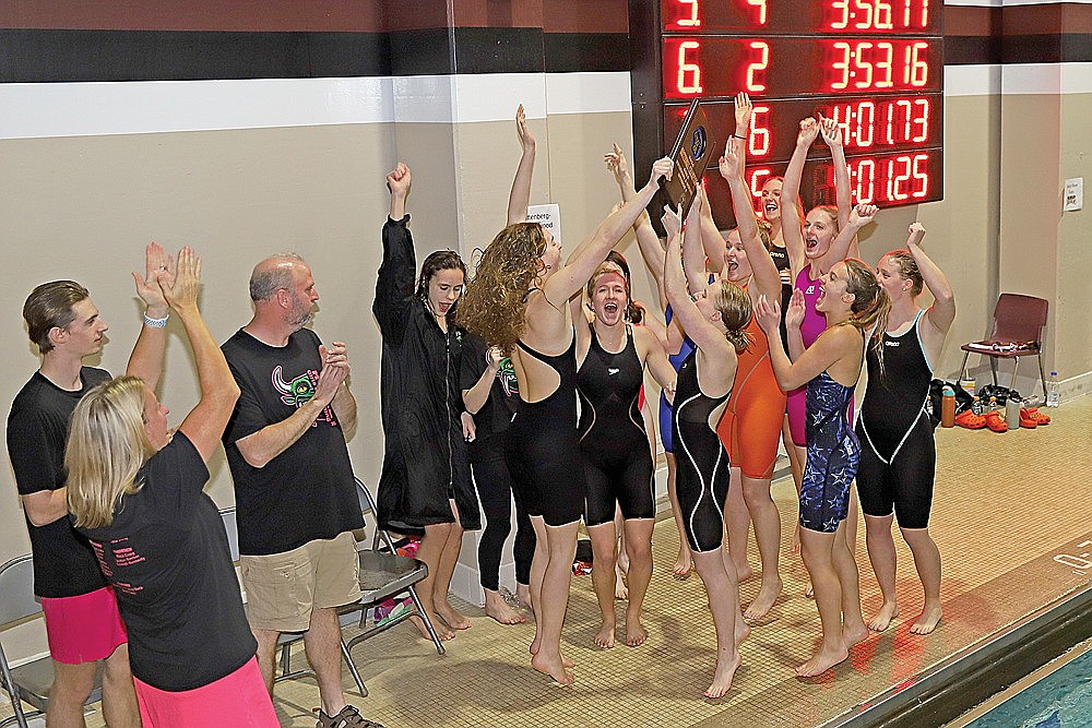 In this Nov. 9, 2024 file photo, the Rhinelander High School girls’ swim team celebrates with the WIAA Division 2 sectional championship plaque after winning the sectional meet in Menomonie Saturday, Nov. 9. The Hodags won their sixth consecutive sectional championship this fall. (Bob Mainhardt for the River News)