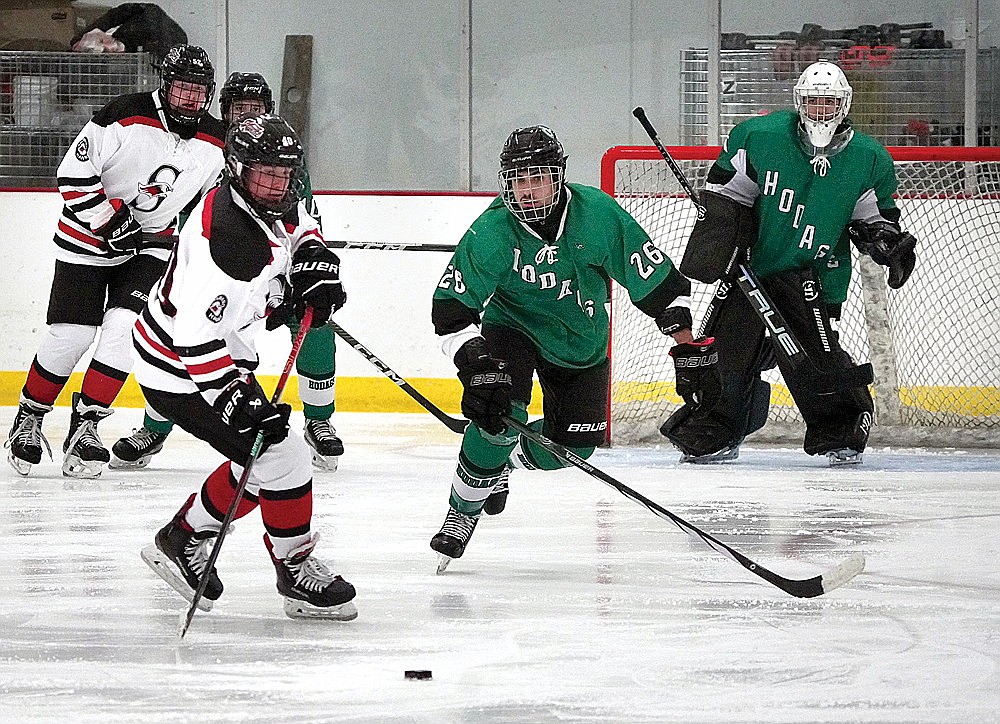 Rhinelander's Timber Cronauer chases Shawano's Jeremy Helmuth for the puck during a non-conference boys' hockey game in Shawano Tuesday, Nov. 26. The Hodags fell to the Hawks, 5-1. (Greg Mellis/Shawano Leader)