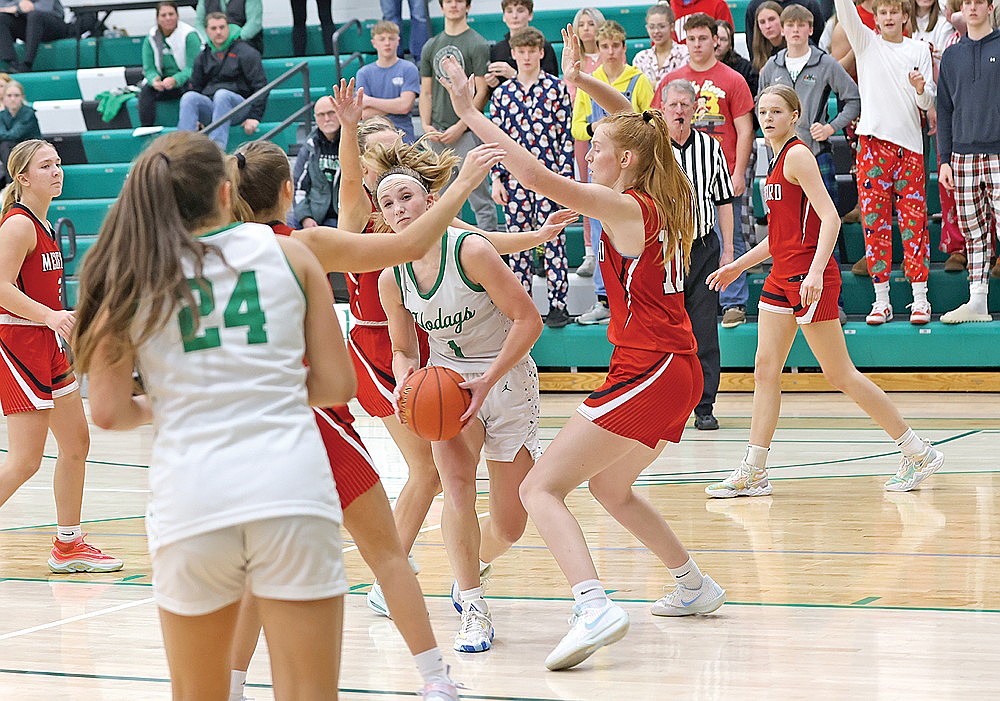 Rhinelander’s Aubryn Clark fights through Medford defenders on a basket attempt during overtime of a GNC girls’ basketball game at the Jim Miazga Community Gymnasium Tuesday, Dec. 3. Clark scored a school-record 43 points as the Hodags rallied to defeat the Raiders, 63-58. (Bob Mainhardt for the River News)