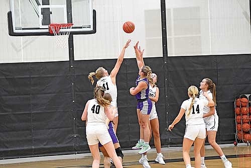 Saylor Timmerman (41) and Alyssa Erickson (15) contest the shot of Mosinee’s Taelyn Jirschele in the first half Tuesday, Dec. 3 at Ted Voigt Court in Minocqua. Jirschele scored 29 points in Timmerman’s first game of the season. (Photo by Brett LaBore/Lakeland Times)