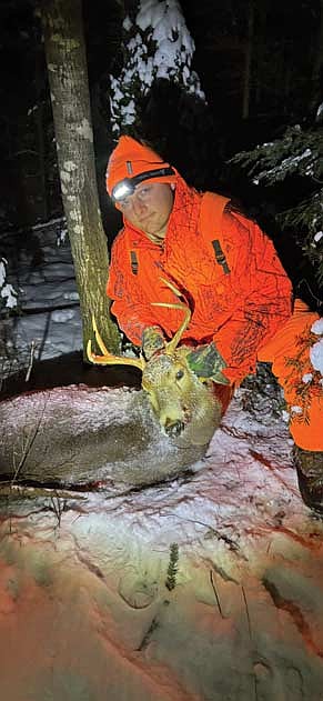 Me posing with the 4-pointer I shot with my dad’s rifle about 15 minutes before shooting hours expired around 4:30 p.m. on Friday, Nov. 29. (Photo by Trevor Greene/Lakeland Times)