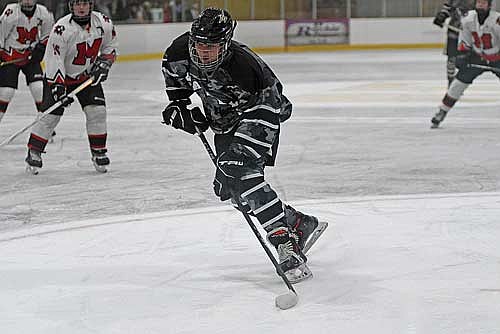 Dominic Gironella controls the puck before shooting and scoring his second goal of the first period against Medford Thursday, Dec. 5 at Lakeland Hawks Ice Arena in Minocqua. Gironella delivered a hat trick in the game. (Photo by Brett LaBore/Lakeland Times)