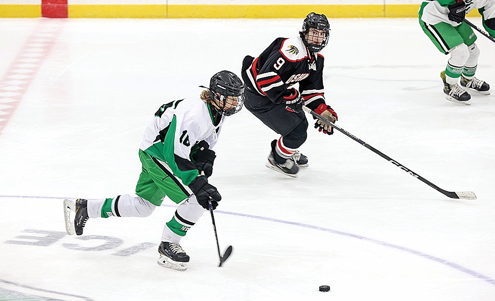 Rhinelander’s Drake Nelson skates through the neutral zone, chased by Oshkosh’s Brennon Kraft during the second period of a non-conference hockey game at the Rhinelander Ice Arena Saturday, Dec. 7. Nelson recorded his first career hat trick Dec. 5 at Antigo, but the Hodags lost the contest, 6-4. (Bob Mainhardt for the River News)