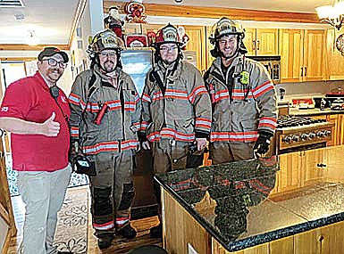 Minocqua firefighters responding to the Thanksgiving day call at Connie Campbell’s residence are, from left, Eric Carlson, Luke Taylor, Ben Susor and Steven Brill. (Contributed photograph)