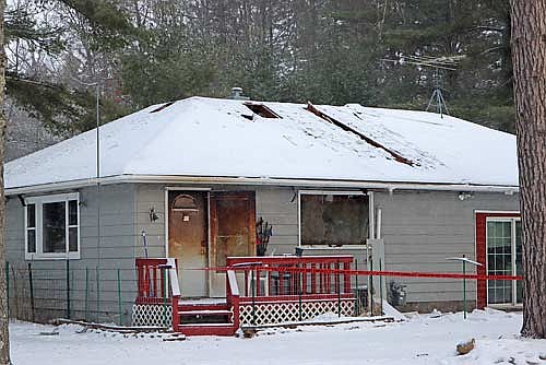 The house on State Highway 155 that was heavily damaged in a fire on Monday, Dec. 9. (Photo by Kate Reichl/Lakeland Times)