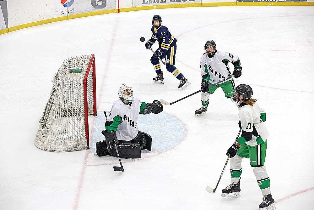 Rhinelander goaltender Asher Rivord looks up at the puck after deflecting a shot in the third period of a GNC boys’ hockey game against Tomahawk at the Rhinelander Ice Arena Thursday, Dec. 12. Rivord tallied a career-high 58 saves in a 10-0 loss to the top-ranked Hatchets. (Bob Mainhardt for the River News)