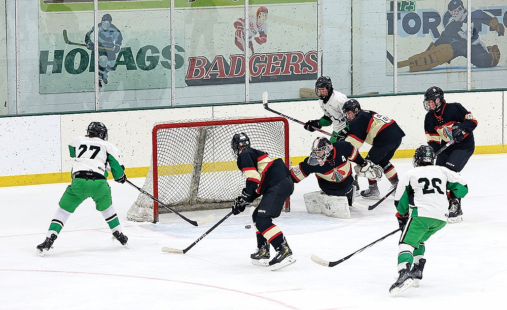 Rhinelander’s Karter Massey (27) tries to tip home a loose puck during the first period of a non-conference boys’ hockey game against Pacelli at the Rhinelander Ice Arena Tuesday, Dec. 17. Pacelli goalie Isaac Andrich made the save on the play and the Cardinals went on to defeat the Hodags, 3-2. (Bob Mainhardt for the River News)