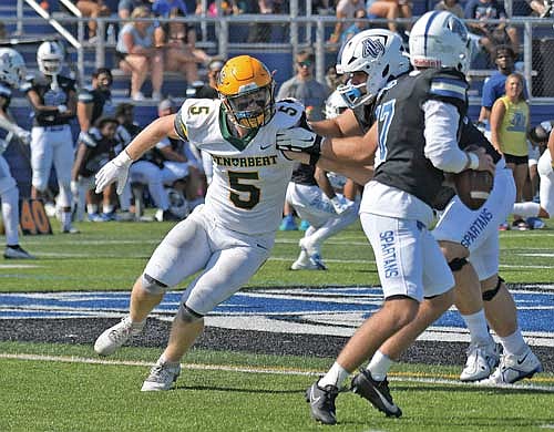 River Nicklaus rushes the quarterback in a game against Aurora University Sept. 21 at Spartan Athletic Park in Montgomery, Ill. (Photo by Cat Wavrunek)