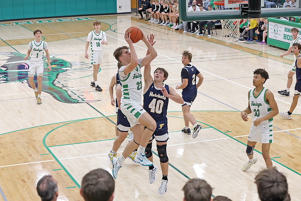 Rhinelander’s Evan Shoeder drives to the basket against Tomahawk’s Tyler Sundquist during the first half of a GNC boys’ basketball game at the Jim Miazga Community Gymnasium Friday, Dec. 20. Shoeder scored a game-high 15 points as the Hodags defeated the Hatchets, 76-22. (Bob Mainhardt for the River News)