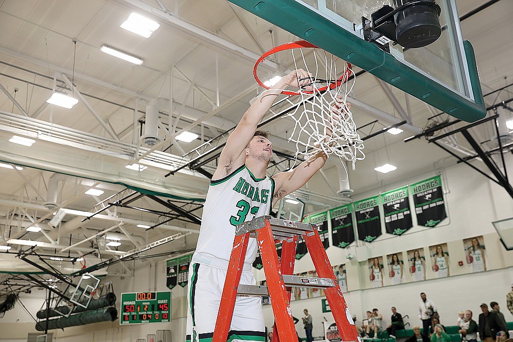 In this Feb. 22, 2024 file photo, Rhinelander senior James Heck cuts down the net after the Hodags defeated Medford 50-45 to win a share of the GNC boys’ basketball title at the Jim Miazga Community Gymnasium. Hodag Hoops’ first conference title since 2018 has been named the top local sports story of 2024 by the River News. (Bob Mainhardt for the River News)