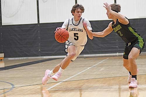 Lincoln Friedley dribbles the ball against the defense of Edgar’s Maverick Butt in the first half Friday, Jan. 3 at Ted Voigt Court in Minocqua. Friedley scored nine points off the bench. (Photo by Brett LaBore/Lakeland Times)