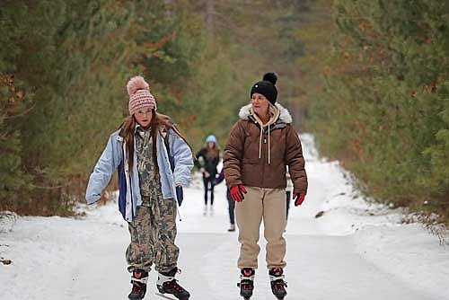 Kaigan Luthy, right, and Keschian Luthy skate down “The Glide” at Boulder Junction’s Winter Park on Tuesday, Dec. 31. (Photo by Kate Reichl/Lakeland Times)