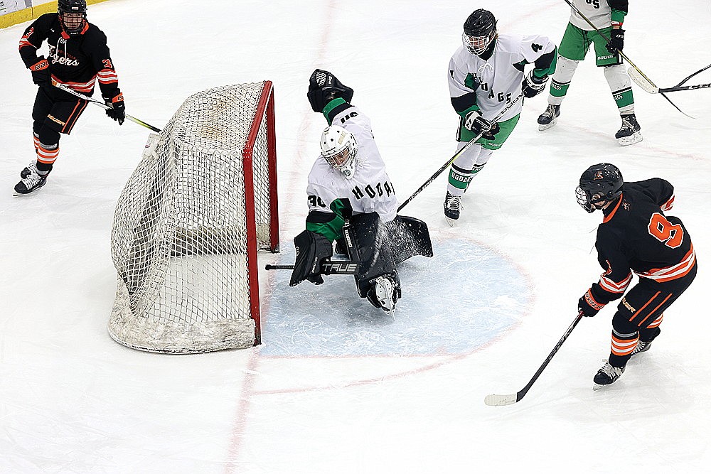 Marshfield’s Cole Kinney beats Rhinelander goalie Asher Rivord for a goal during the first period of a non-conference boys’ hockey game at the Rhinelander Ice Arena Thursday, Jan. 2. The Tigers scored four times in each of the first two periods to defeat the Hodags, 8-0. (Bob Mainhardt for the River News)