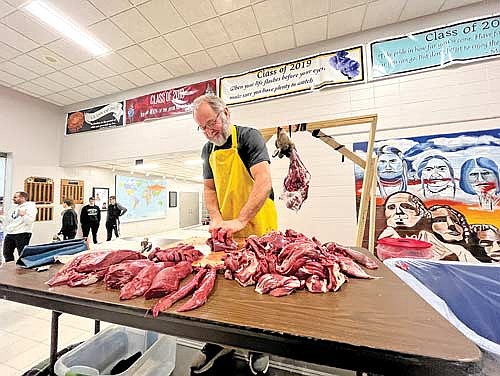 Don Bus butchers a deer in order to teach young hunters how to skin and butcher their harvests themselves. (Photo by Trevor Greene/Lakeland Times)