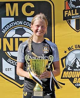 Malin Awker celebrates with the trophy after her Marathon County United (MCU) state team won the Mountain Bay Cup Championship in 2024. (Contributed photograph)