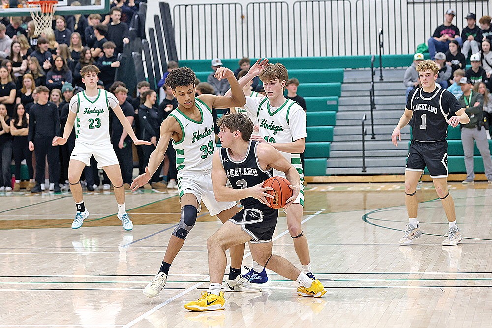 Rhinelander’s Nahzeair Boykin (33) and Seth Nofftz (10) double team Lakeland’s Noah Bruckner during the second half of a GNC boys’ basketball game at the Jim Miazga Community Gymnasium Friday, Jan. 10. The Hodags held Lakeland to 20% shooting and forced 28 turnovers in a 70-30 victory. (Bob Mainhardt for the River News)