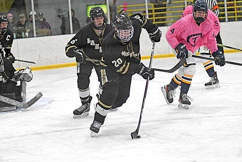 Brent Olson controls the puck with Lawson Bain following in the third period against Tomahawk Tuesday, Jan. 14 at Sara Park Ice Arena in Tomahawk. (Photo by Brett LaBore/Lakeland Times)
