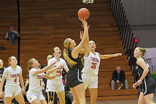 Saylor Timmerman takes a shot surrounded by a trio of Tigers, including Marshfield’s Emma Ridgway (25) in the first half of a 60-49 victory Monday, Jan. 13 at the Fredrick Construction Fieldhouse in Marshfield. (Photo by Brett LaBore/Lakeland Times)